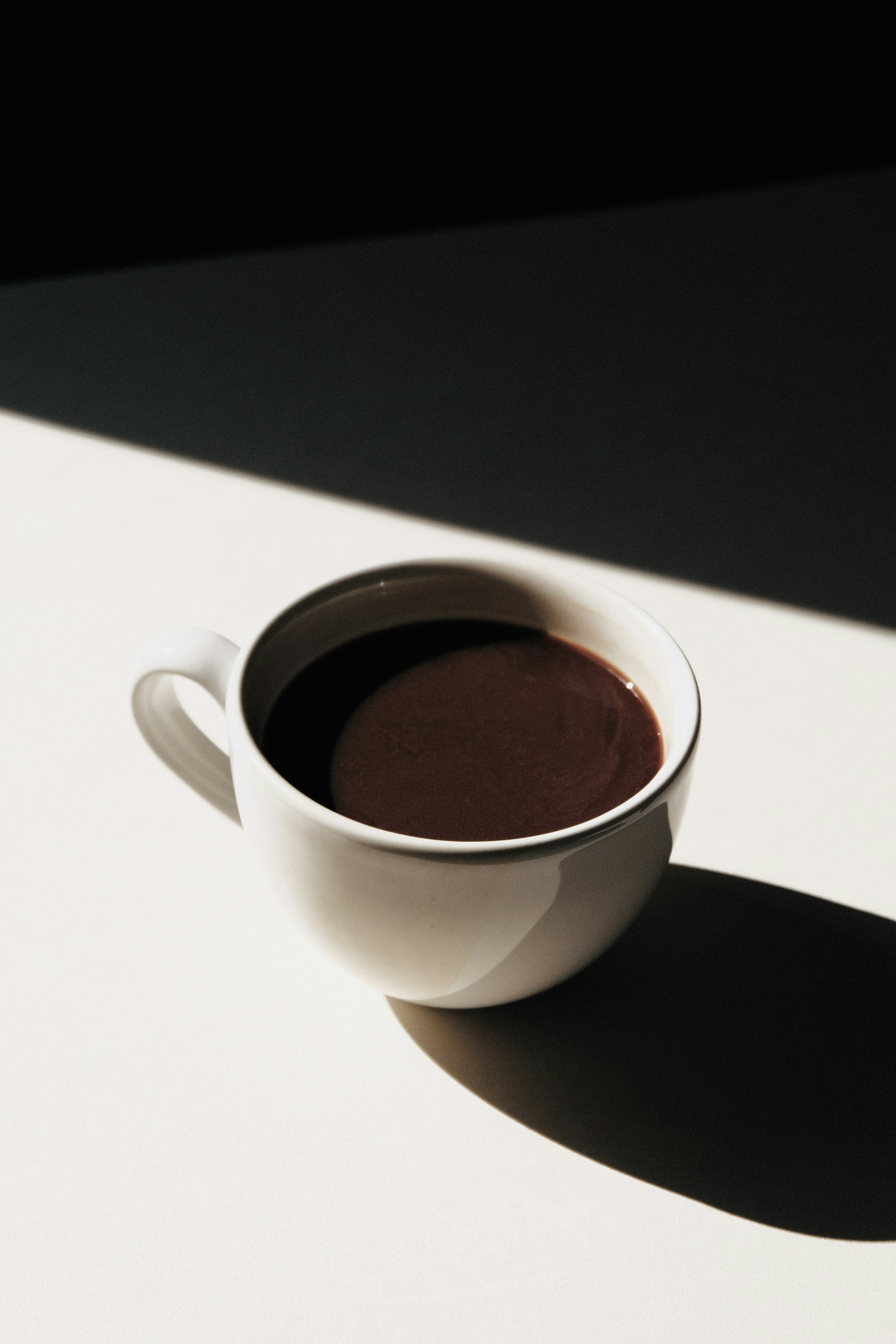 A white cup of coffee in natural light